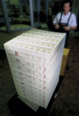 An undated handout picture shows a worker transporting a pallet of sheets of Eur