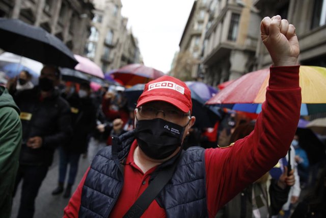 Archivo - Un home amb el puny alçat i una gorra de CCOO en una concentració convocada a Barcelona, a 1 de maig del 2021, a Barcelona, Catalunya