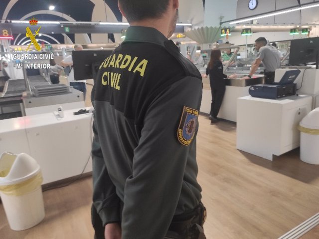 Agentes de la Guardia Civil, en un control de pasajeros y equipajes en el Aeropuerto de Sevilla.