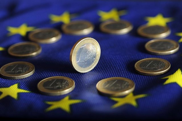 Archivo - Imatge d'unes monedes d'euro sobre la bandera de la UE