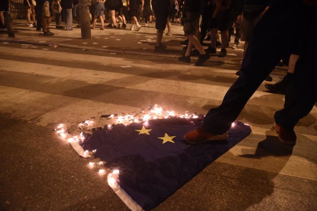 Diversos manifestants cremen una bandera de la UE a Tessalònica, Grècia.