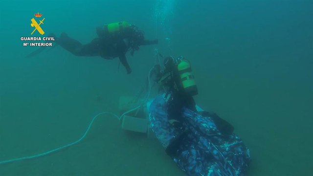 Miembros del grupo GEAS tratan de recuperar los paquetes de hachís fondeados.