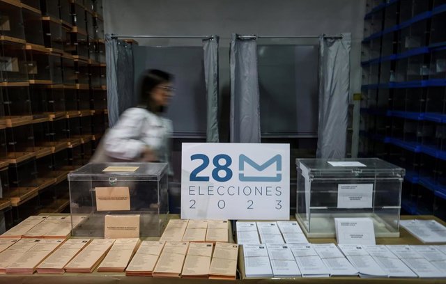 Archivo - Imagen de archivo de una persona junto a papeletas y urnas electorales de los comicios del 28M. 