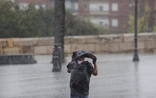 Una persona camina bajo la lluvia, a 15 de septiembre de 2023, en València, Comunidad Valenciana (España). Las tormentas, en algunos casos de intensidad fuerte, están recorriendo durante las primeras horas de la mañana de este viernes los litorales de Val