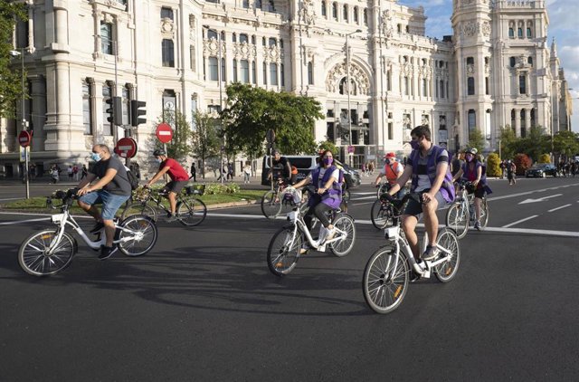 Archivo - Varias personas en bicicleta a la altura del Palacio de Cibeles