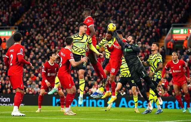 23 December 2023, United Kingdom, Liverpool: Liverpool goalkeeper Alisson Becker punches the ball away from danger during the English Premier League soccer match between Liverpool and Arsenal at Anfield.