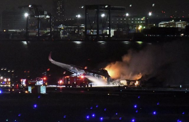 TOKYO, Jan. 2, 2024  -- Firefighters work at the site of an aircraft collision at Haneda Airport in Tokyo, Japan, Jan. 2, 2024. 