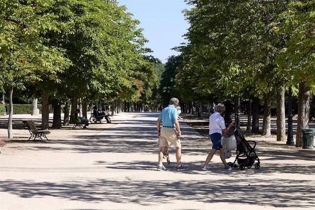 Archivo - Varias personas pasean con un carrito de bebé en el parque de El Retiro, a 29 de julio de 2023, en Madrid (España). 