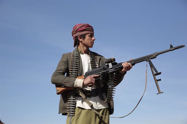 Un  hombre sostiene un arma y se manifiesta en apoyo de los hutíes en Saná, Yemen