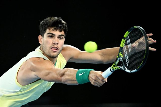 El tenista español Carlos Alcaraz intenta devolver una bola en su duelo de cuartos de final del Abierto de Australia 2024 ante el alemán Alexander Zverev